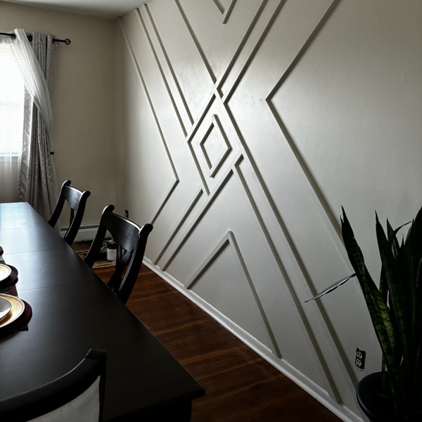 A dining room with a freshly painted wall, adding a touch of color and freshness to the space.