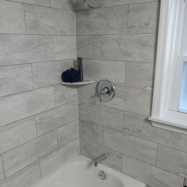 A bathroom with a shower and tub, providing a relaxing and refreshing space for personal hygiene.