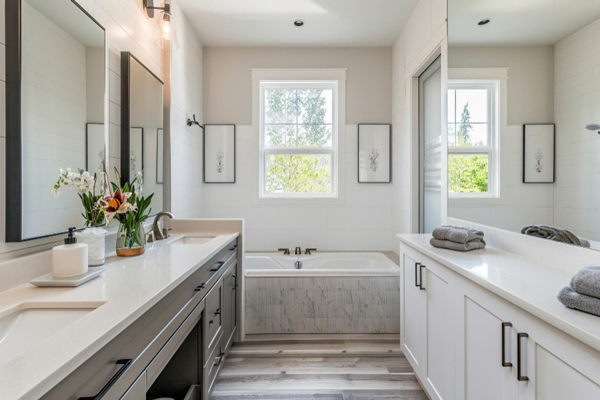 A pristine bathroom featuring a spacious tub and sink.